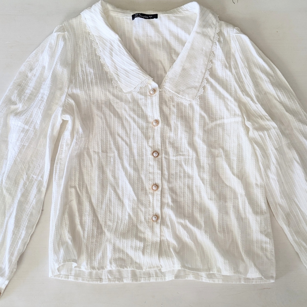 White long-sleeved blouse with ruffle collar